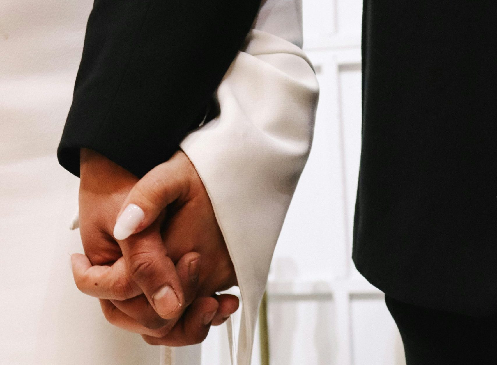 couple holding hands wedding ceremony