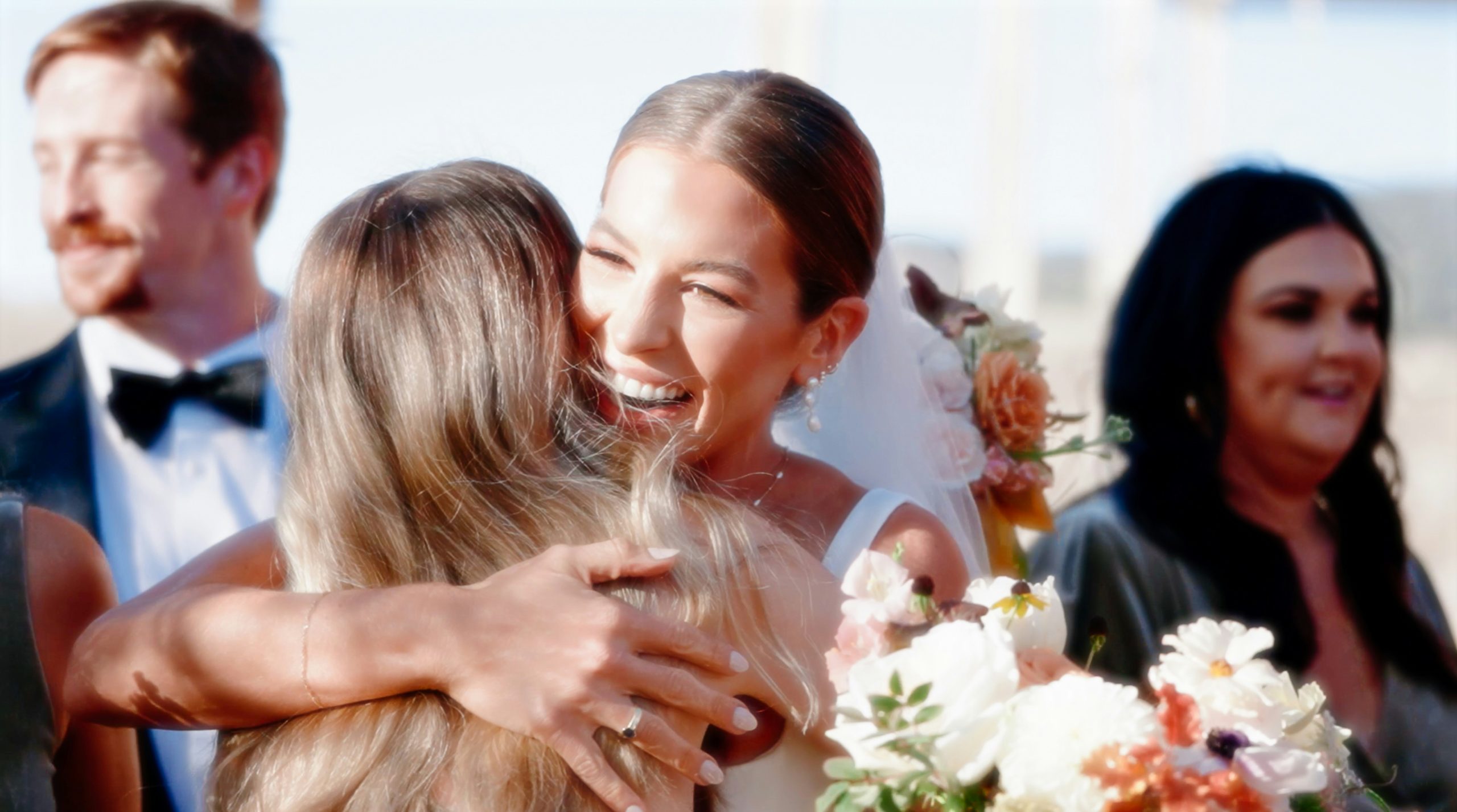 family hugging wedding day